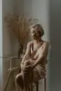 Sophisticated senior woman in a stylish pose indoors by a window.