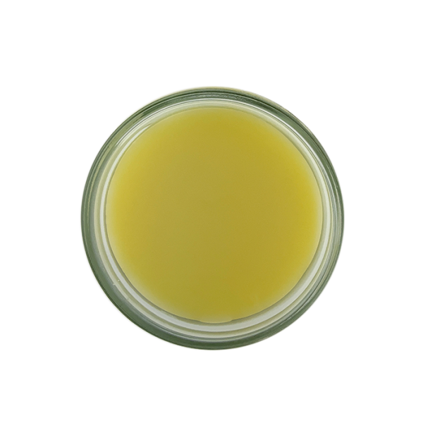 Natural beeswax cream jar photographed from above top down